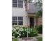 Charming two-story home with white siding, brick accents, and an American flag, surrounded by lush hydrangeas and landscaping at 10629 Simsbury Ct, Indianapolis, IN 46236