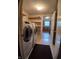 Laundry room featuring a washer, dryer, and shelving for storage, with a glimpse into another room at 10629 Simsbury Ct, Indianapolis, IN 46236
