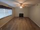 Bright living room featuring a fireplace, large window and modern floors at 10629 Simsbury Ct, Indianapolis, IN 46236