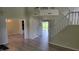 Spacious living room showcasing wood floors, staircase, and ample natural light from sliding glass doors at 10629 Simsbury Ct, Indianapolis, IN 46236