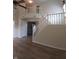 Spacious living room showcasing an open floor plan with wood flooring and a staircase leading to a second story at 10629 Simsbury Ct, Indianapolis, IN 46236