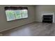 Living room featuring fireplace, large window and modern floors at 10629 Simsbury Ct, Indianapolis, IN 46236