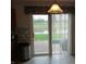 View from inside, featuring a patio door with vertical blinds and a glimpse of the backyard and a pond at 10629 Simsbury Ct, Indianapolis, IN 46236