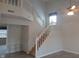 Grand foyer staircase with white banisters and a view of the upper level, creating a welcoming atmosphere at 10629 Simsbury Ct, Indianapolis, IN 46236