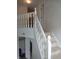 Bright staircase with white railings, carpeted steps, and open landing at 10629 Simsbury Ct, Indianapolis, IN 46236