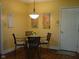 Charming breakfast nook with stylish lighting fixture and seating for four at 10916 President Cir, Indianapolis, IN 46229