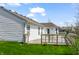 View of the back of the home featuring a wooden deck with outdoor seating at 11631 Tucker Ct, Indianapolis, IN 46229
