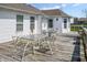 Spacious back deck of home with white railing and patio seating for entertaining at 11631 Tucker Ct, Indianapolis, IN 46229
