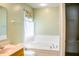 Bathroom with a soaking tub and access to a walk-in closet, creating a spa-like atmosphere at 11631 Tucker Ct, Indianapolis, IN 46229