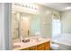 Bathroom with double sinks, soaking tub and walk-in shower, offering a serene and functional space at 11631 Tucker Ct, Indianapolis, IN 46229