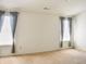 Spacious bedroom features carpeted floors and large windows with neutral curtains at 11631 Tucker Ct, Indianapolis, IN 46229