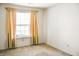 Inviting bedroom featuring a window with curtains and neutral carpeting ready for updates at 11631 Tucker Ct, Indianapolis, IN 46229