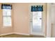 Dining area boasts a door to the backyard and a sunny window with blue curtains at 11631 Tucker Ct, Indianapolis, IN 46229