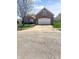 Charming brick home with a two-car garage and a concrete driveway at 11631 Tucker Ct, Indianapolis, IN 46229