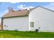 View of side of house showing siding, AC unit, and back yard at 11631 Tucker Ct, Indianapolis, IN 46229