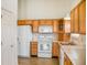 Updated kitchen featuring white appliances and wood cabinets and eat-in space at 11631 Tucker Ct, Indianapolis, IN 46229