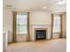 Bright living room featuring a fireplace and large windows with curtains at 11631 Tucker Ct, Indianapolis, IN 46229