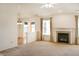 Open living room with a fireplace and view into the dining and kitchen areas at 11631 Tucker Ct, Indianapolis, IN 46229