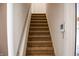 Carpeted stairs lead to upper level featuring a convenient wall-mounted control panel at 11631 Tucker Ct, Indianapolis, IN 46229