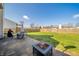 Spacious backyard featuring a stone patio with a fire pit, outdoor seating, and a well-maintained lawn at 1231 Chesterfield Dr, Anderson, IN 46012