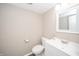 Bright bathroom featuring a white vanity, toilet, sink, and a neutral wall color at 1231 Chesterfield Dr, Anderson, IN 46012