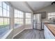 Bright dining area featuring a stainless steel refrigerator, a garden view, and modern flooring at 1231 Chesterfield Dr, Anderson, IN 46012