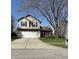 Two-story home featuring a front yard, driveway, and attached garage at 1231 Chesterfield Dr, Anderson, IN 46012