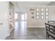 Hallway view with gray-toned wood floors, showing stairs and a decorative wall at 1231 Chesterfield Dr, Anderson, IN 46012