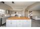 Open kitchen with gray cabinets, a butcher block island, stainless steel appliances, and views of the staircase at 1231 Chesterfield Dr, Anderson, IN 46012