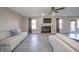 Bright living room features a fireplace, modern ceiling fan, and neutral sofas at 1231 Chesterfield Dr, Anderson, IN 46012