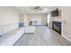 Spacious living room offers laminate flooring, a fireplace, and a ceiling fan at 1231 Chesterfield Dr, Anderson, IN 46012