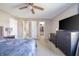 Bedroom features a large bed, walk-in closet, an en-suite bathroom, and a modern ceiling fan at 1231 Chesterfield Dr, Anderson, IN 46012