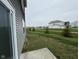 The home has a spacious backyard and neighbors homes beyond the lawn at 1268 Newton St, Avon, IN 46123