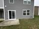 The gray home features a sliding door to a concrete patio and a grassy backyard at 1268 Newton St, Avon, IN 46123