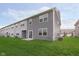 Home backyard featuring a well-manicured lawn and a modern gray-toned home exterior at 1268 Newton St, Avon, IN 46123