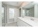 Modern bathroom with double sink vanity, large mirror, and tiled shower, with lots of light at 1268 Newton St, Avon, IN 46123
