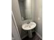 This well-lit half bathroom features a pedestal sink and neutral colored walls, for added convenience and style at 1268 Newton St, Avon, IN 46123
