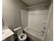 This bathroom features a tub with white subway tile surround and a toilet with open lid at 1268 Newton St, Avon, IN 46123