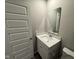 This bathroom features a white single sink vanity with a chrome faucet, a mirror, and toilet at 1268 Newton St, Avon, IN 46123