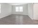 Bright, spacious bedroom with wood-look flooring, two windows, and a sliding barn door at 1268 Newton St, Avon, IN 46123