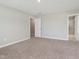 Well-lit bedroom with neutral walls and carpet flooring, and an attached bathroom at 1268 Newton St, Avon, IN 46123