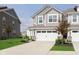 Beautiful townhome with a two-car garage, well-maintained lawn, and attractive landscaping at 1268 Newton St, Avon, IN 46123