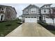 Charming gray two-story townhouse featuring a white two car garage and concrete driveway at 1268 Newton St, Avon, IN 46123