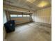 A spacious two-car garage features concrete floor, overhead door and overhead door mechanism at 1268 Newton St, Avon, IN 46123