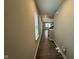 Long hallway with wood floors and neutral walls leading to an open living space at 1268 Newton St, Avon, IN 46123