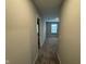 This hallway leads to a carpeted bedroom with natural light and a view of the neighborhood at 1268 Newton St, Avon, IN 46123
