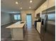 This open kitchen features stainless steel appliances and a large island with bar seating, perfect for entertaining at 1268 Newton St, Avon, IN 46123