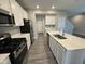 Bright kitchen with white cabinets, stainless appliances, and center island with sink at 1268 Newton St, Avon, IN 46123