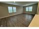 Bright and open living room with wood floors and ample natural light from large windows at 1268 Newton St, Avon, IN 46123