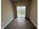 Empty room with wood floors and a glass sliding door to an outdoor space at 1268 Newton St, Avon, IN 46123
